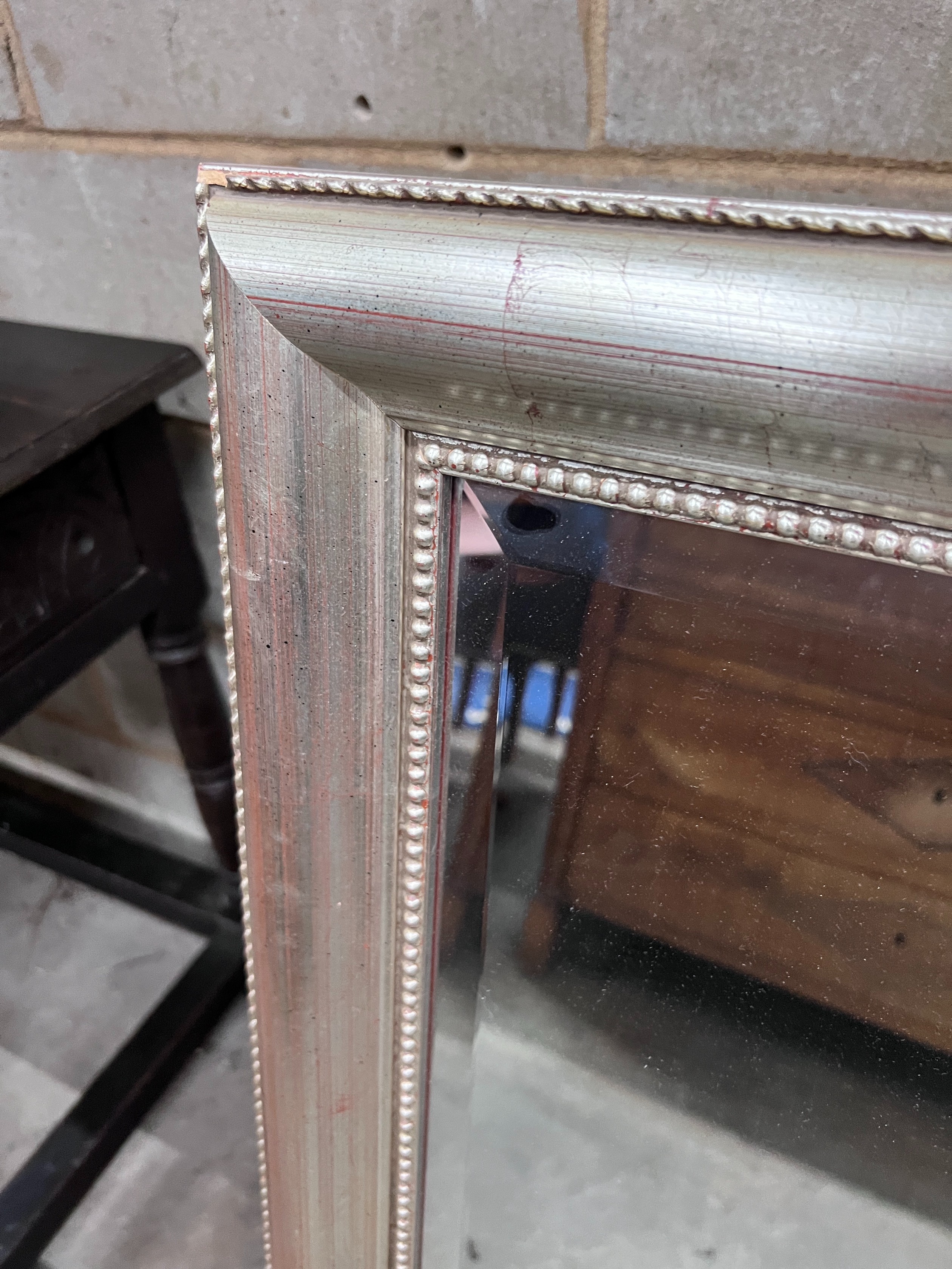 A silvered wood framed wall mirror, width 74cm, height 105cm *Please note the sale commences at 9am.